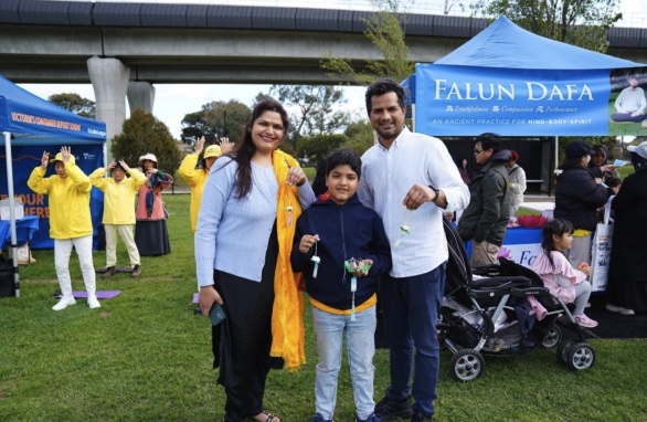 Bikram Singh with his family at the Falun Dafa booth