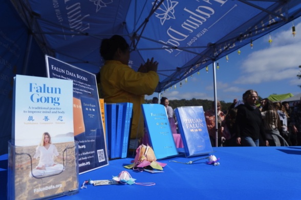 Falun Dafa display with lotus flowers on the table