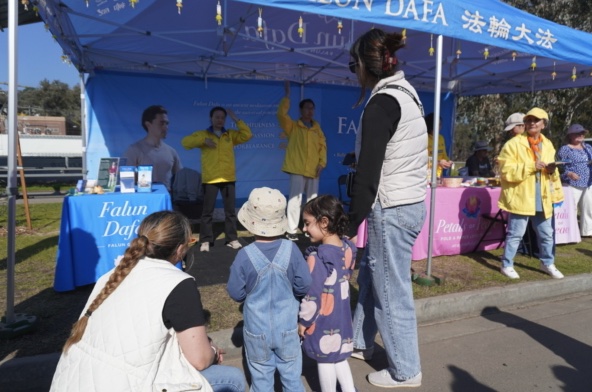 Falun Dafa practitioners demonstrating the five exercises at the booth