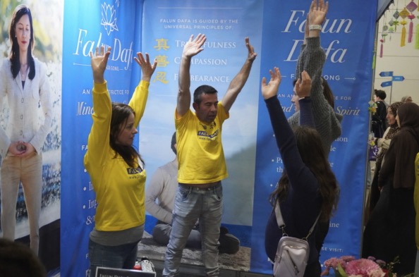 Visitors at the Falun Dafa booth